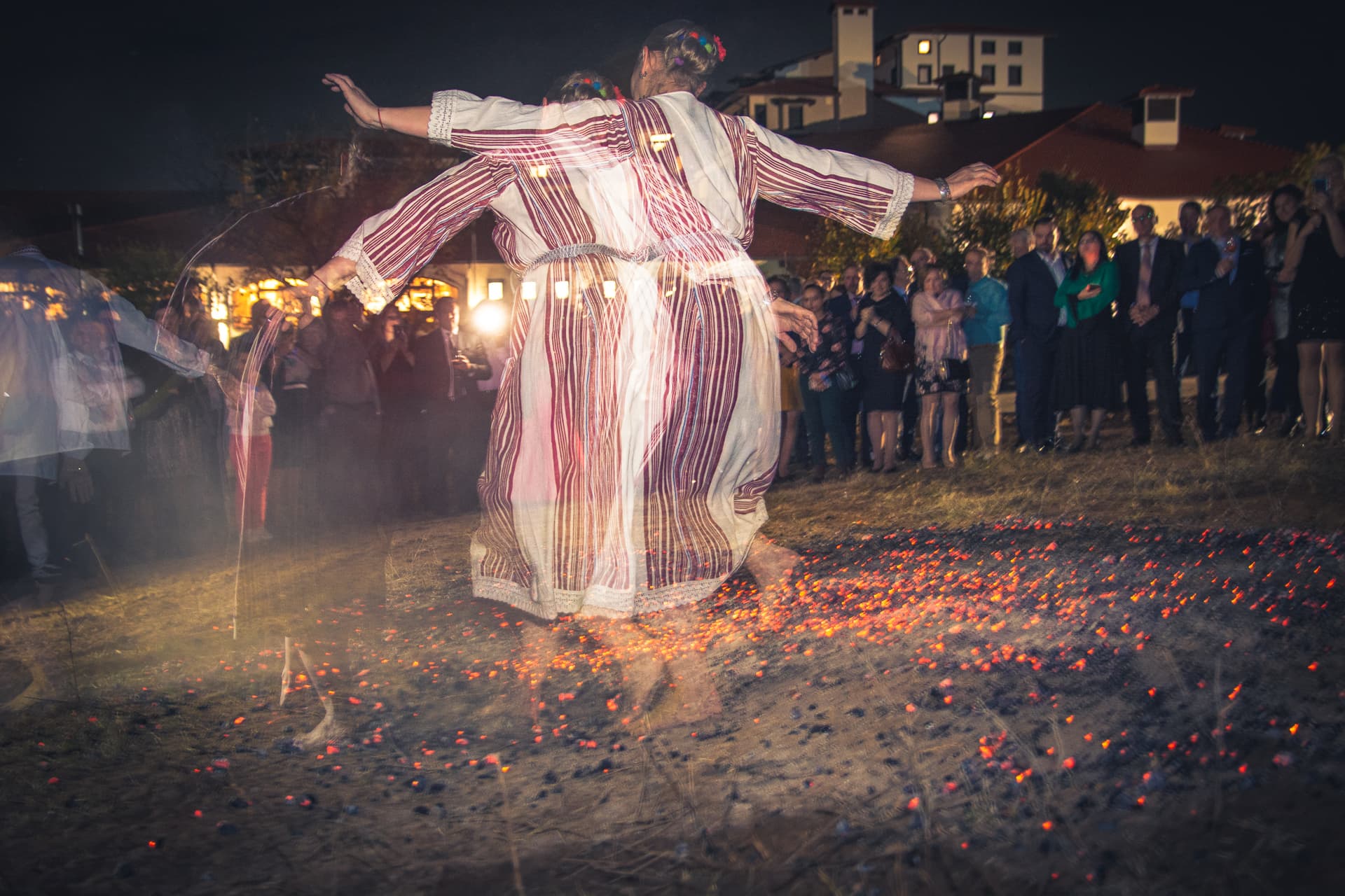 A nestinar fire dancer on embers