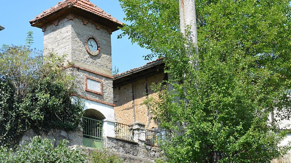 The old clock tower in Svezhen, half hidden by trees