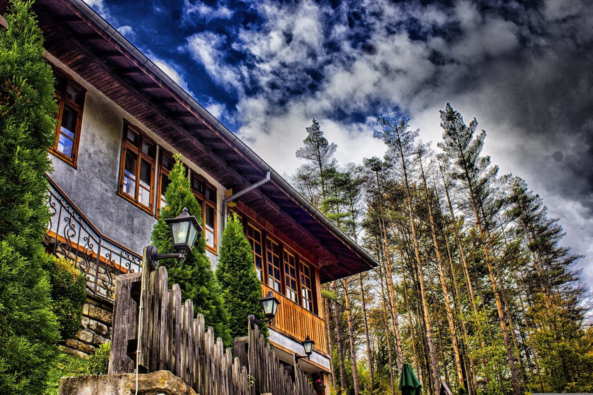 A timber-and-stone lodging building among the pines at the edge of the complex