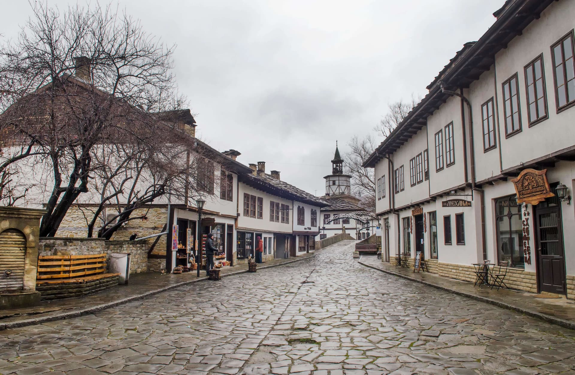 The cobbled Revival square at Tryavna, lined with white timber-framed houses and the clock tower at its head