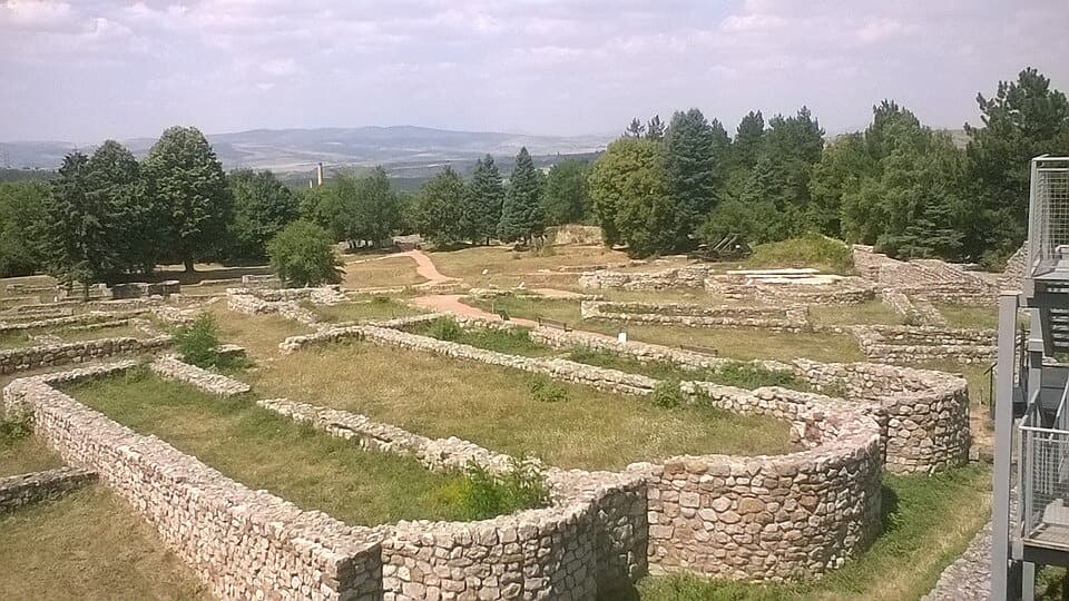 Stone wall foundations of Krakra Fortress spread across the plateau above Pernik