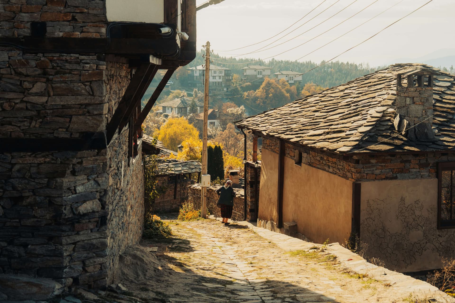 Restored stone guesthouses in Leshten looking out toward the Pirin ridge